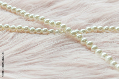 Pearl beads on the pink fabric with copy space.