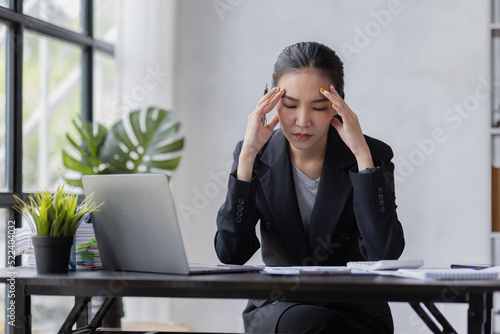 Stress Asian woman business people and work concept, a tired Asian businessman in workplace office desk.