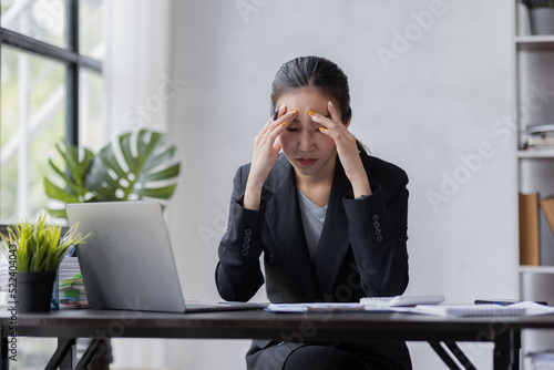 Stress Asian woman business people and work concept, a tired Asian businessman in workplace office desk.