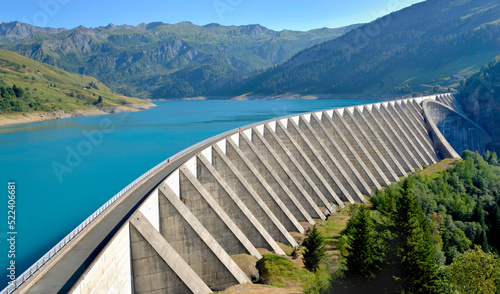 the roselend dam with turquoise water in a mountainous landscape in France photo