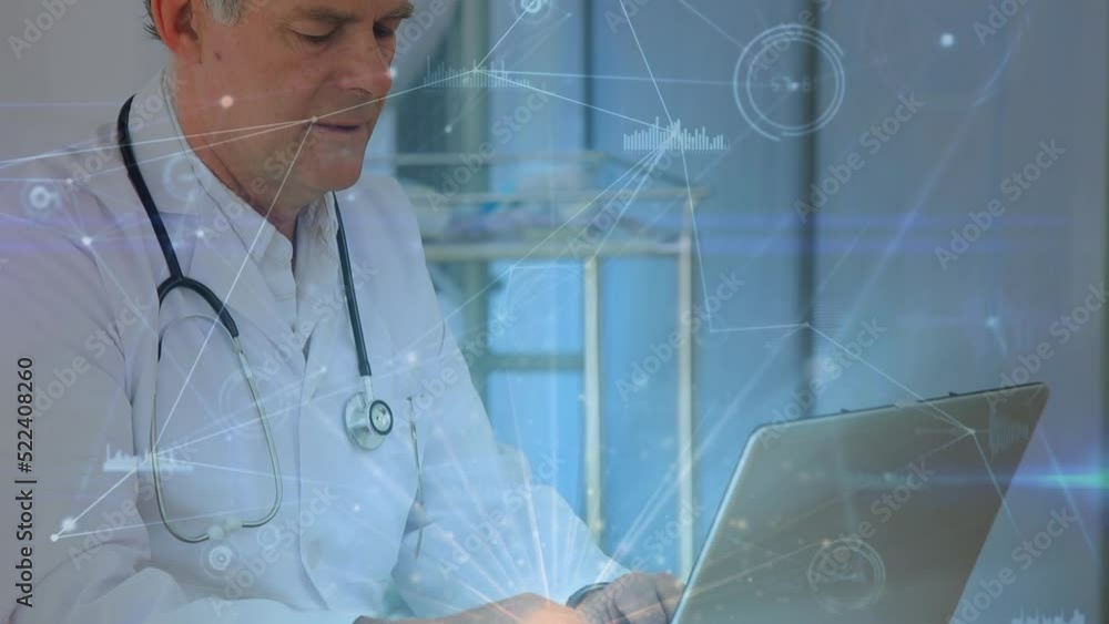 Animation of connections over caucasian senior male doctor using laptop Animation of connections over caucasian senior male doctor using laptop