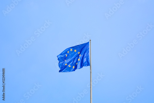 Flag of European Union fluttering on pole outdoors, space for text © New Africa