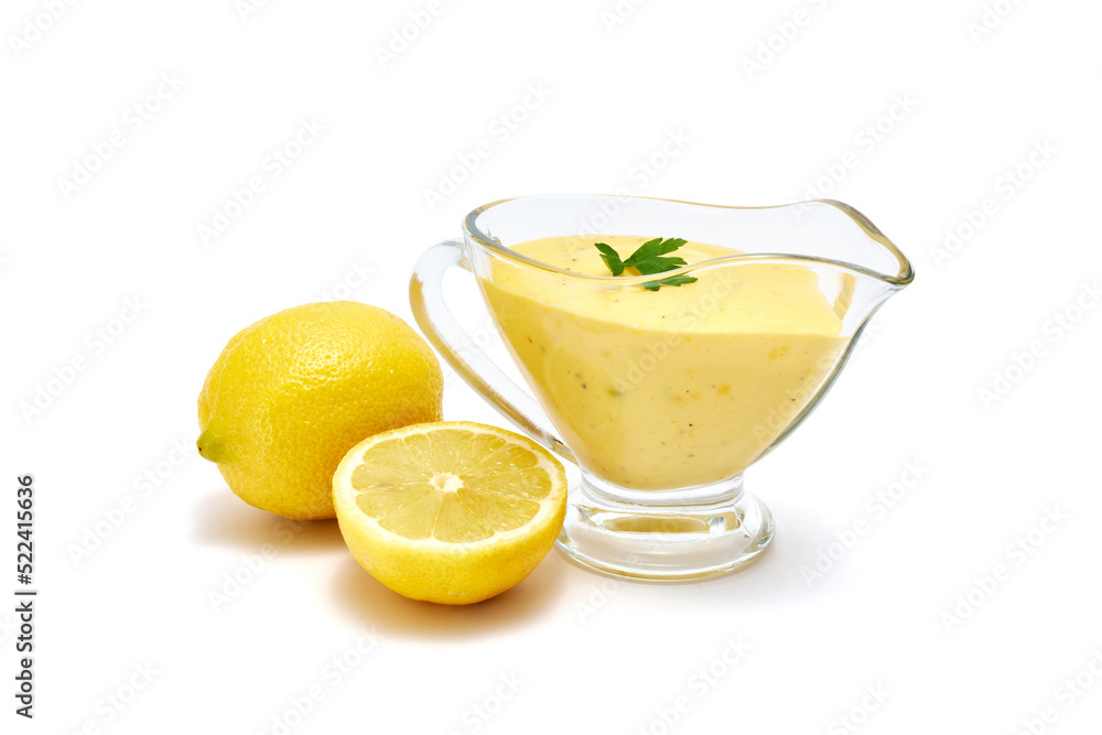 Tasty yellow hollandaise sauce in glass bowl gravy boat isolated on white background Tasty yellow hollandaise sauce in glass bowl gravy boat isolated on white background