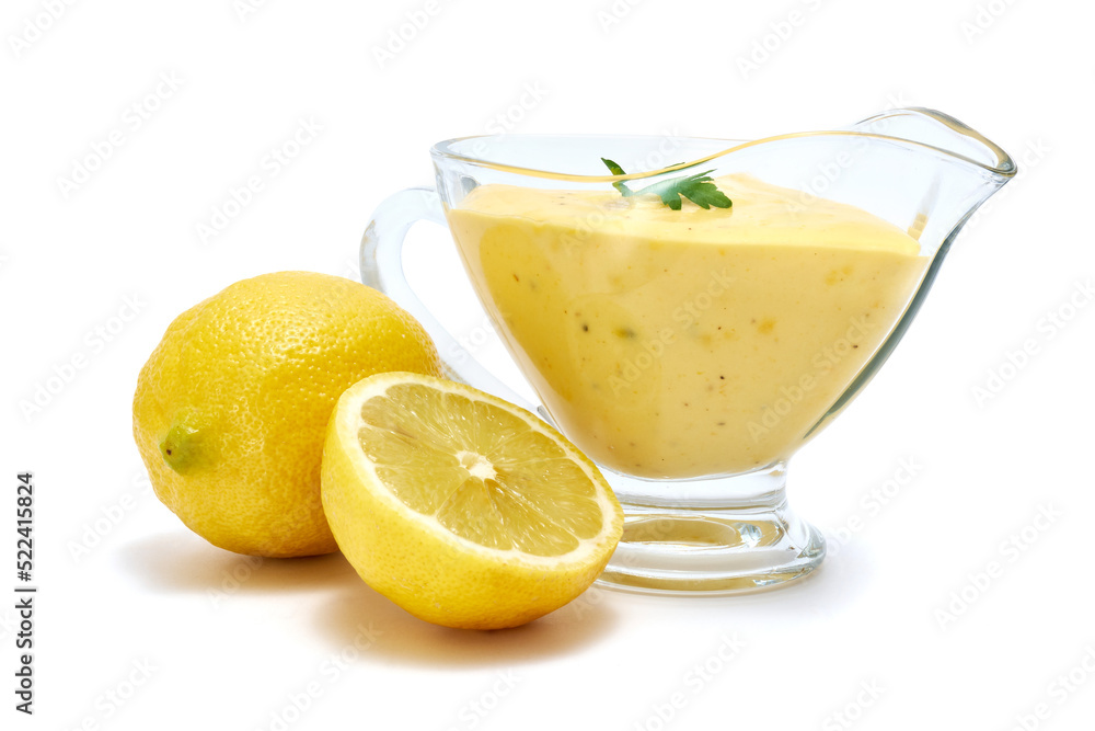 Tasty yellow hollandaise sauce in glass bowl gravy boat isolated on white background