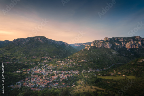 Aerial view of a medieval village, the Rozier agains mountain peak in the Cevennes national park in France