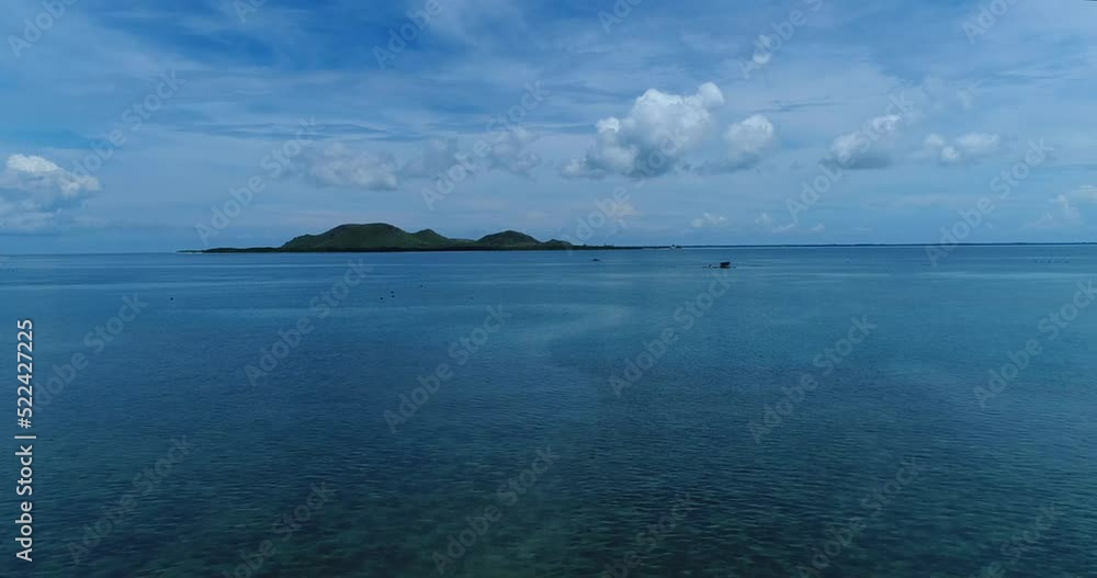 Aerial shot of fishing platforms with boat in front of small island