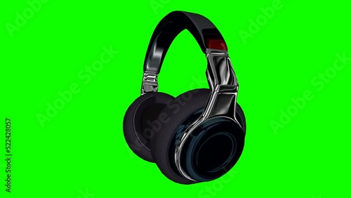 Headphones rotating on green background.
 3D. Chroma key or chroma keying

