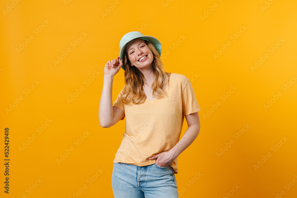 Young blonde woman wearing panama smiling and looking aside Young blonde woman wearing panama smiling and looking aside