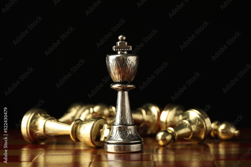 Chessboard with game pieces on black background Chessboard with game pieces on black background