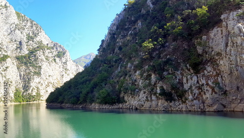 Albania, Lake Koman is a reservoir on the Drin River in northern Albania, surrounded by dense forested hills, vertical slopes, deep gorges and a narrow valley © GCphotographer