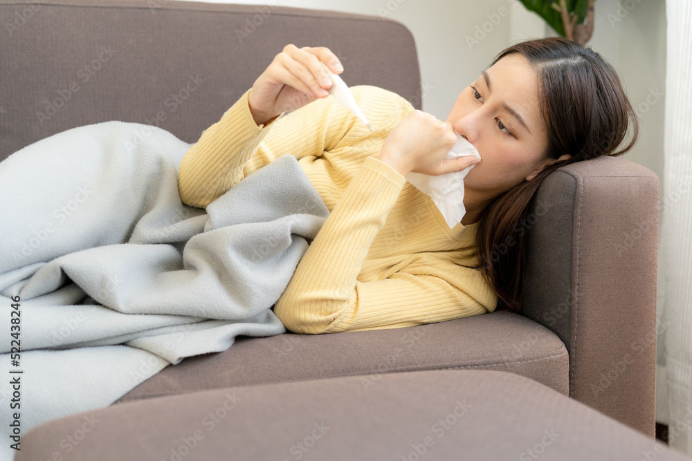 Asian woman sick at home. The woman had a cough, sore throat,runny nose
