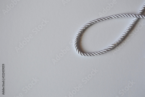 White rope cord silky silver textile tie curved lasso line background 