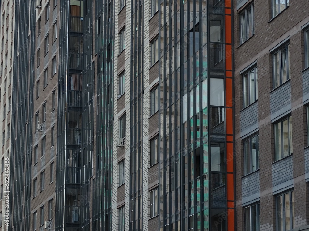 Fototapeta premium Full-color horizontal photo. Linear geometric composition. An inanimate landscape of parts of the facades of city buildings.