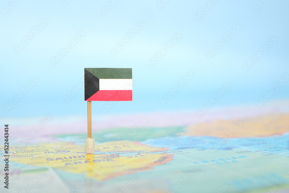 Selective focus of Kuwaiti flag in world map. Kuwait country location and sovereignty concept.