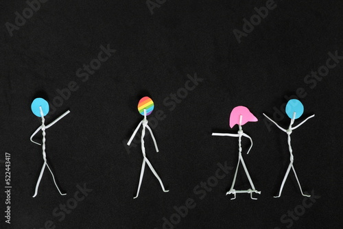LGBT or LGBTQIA bullying, insult and harassment, discrimination and homophobia concept. Human stick figure in dark black background creative composition. photo