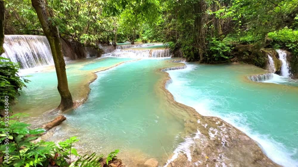 Turquoise blue colours of Kuang Si waterfalls Luang Prabang Laos. these waterfalls in the Mountains of Luang Prabang Laos flow all year round in the natural rainforest Turquoise blue colours of Kuang Si waterfalls Luang Prabang Laos. these waterfalls in the Mountains of Luang Prabang Laos flow all year round in the natural rainforest