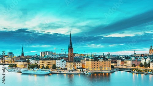 Stockholm, Sweden. Scenic View Of Stockholm Skyline At Summer Evening. Famous Popular Destination Scenic Place In Dusk Lights. Riddarholm Church In Day To Night Transition Time Lapse. photo