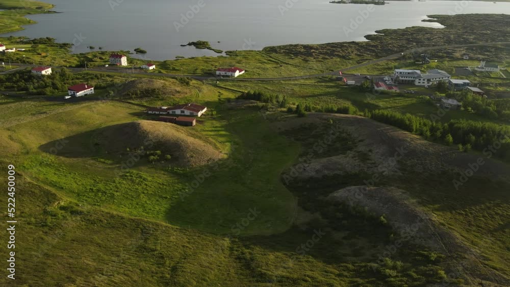 Aerial shot of Reykjahlíð city in Iceland. Beautiful green grass, lake and volcano area in Iceland. Beautiful green environment with lava fields Aerial shot of Reykjahlíð city in Iceland. Beautiful green grass, lake and volcano area in Iceland. Beautiful green environment with lava fields