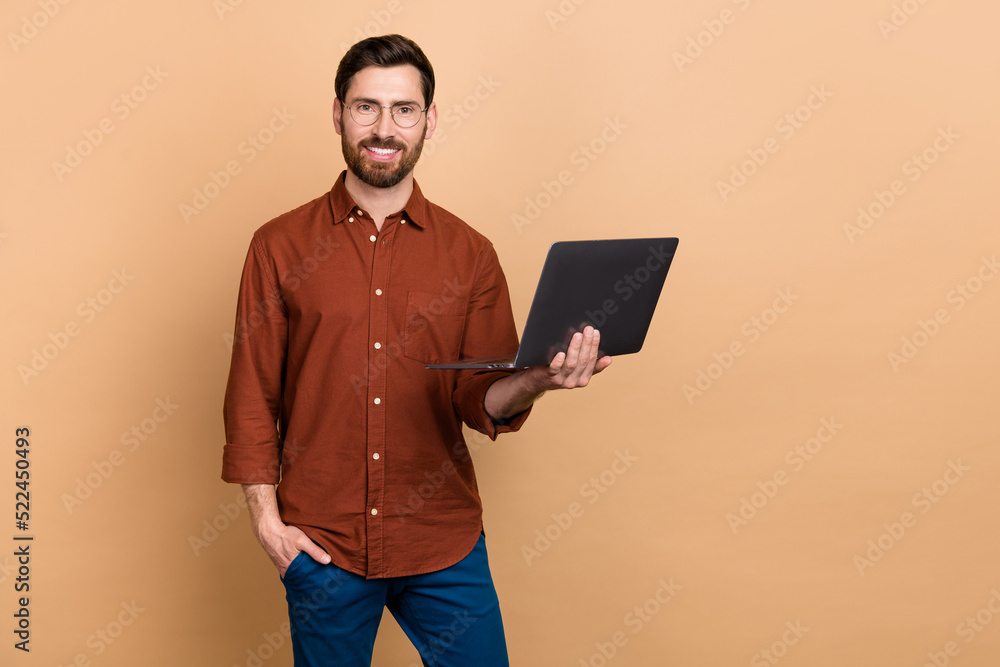 Photo of cheerful intelligent person hold wireless netbook toothy smile isolated on beige color background