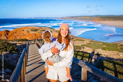 mother with her daughter on the beach in portugal algarve