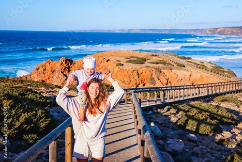mother with her daughter on the beach in portugal algarve