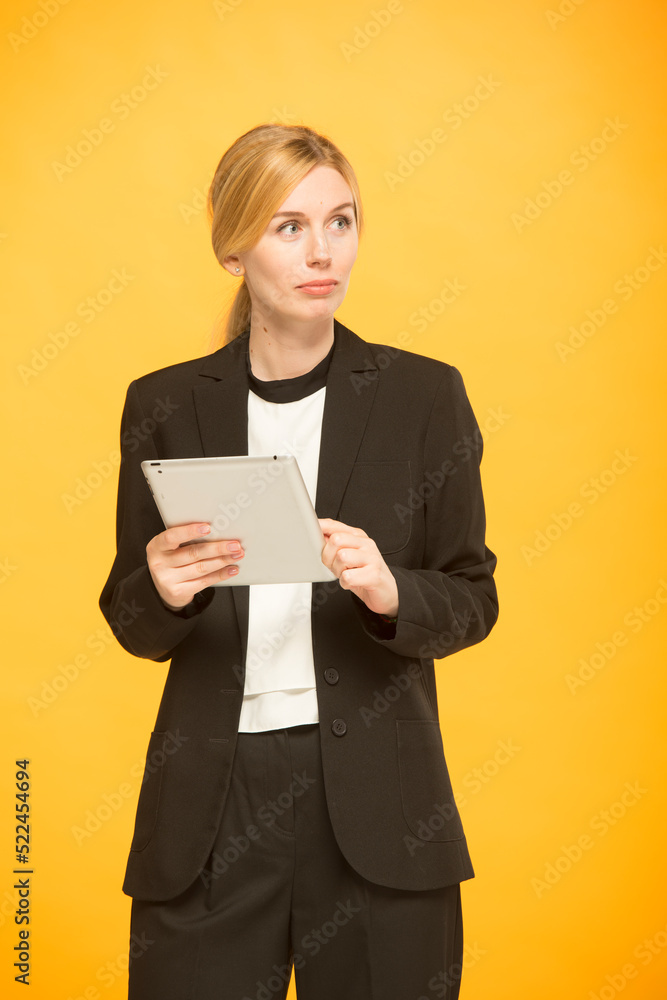 young woman in business clothes is using a tablet isolated