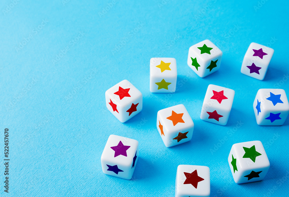 Scattered blocks with colorful stars on a blue background. Feedback. Inspection, review. Benefits, positive things. New features. Copy space Scattered blocks with colorful stars on a blue background. Feedback. Inspection, review. Benefits, positive things. New features. Copy space