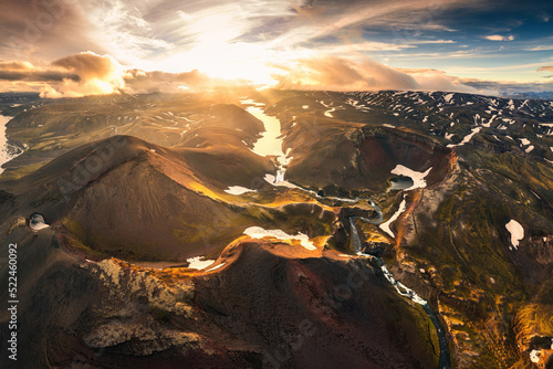 Aerial view of sunset over mysterious volcanic crater and glacier stretches through the central highlands of iceland on summer