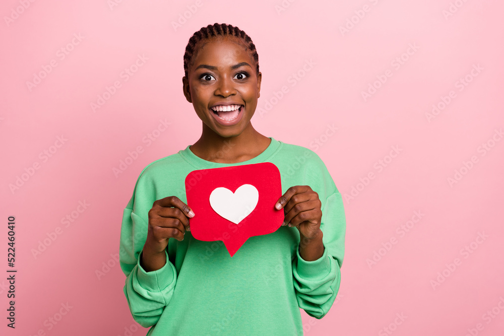 Photo of positive pretty girl hold paper like card look camera isolated on pink color background Photo of positive pretty girl hold paper like card look camera isolated on pink color background