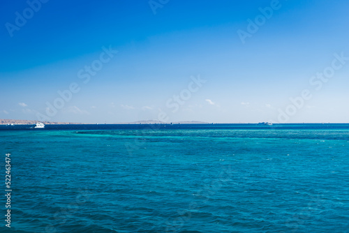 Beautiful seascape near Hurgada, Coast in Egypt Red Sea. Amazing nature background Luxury holiday resort. Boat on the horizon among the blue sea surface