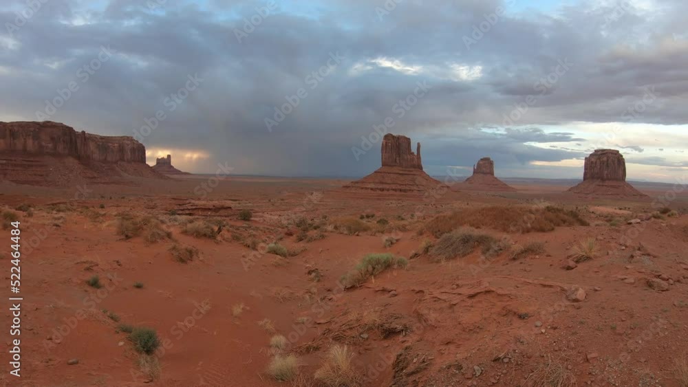 PAN SHOT - The Monument Valley Navajo Tribal Park in Arizona, USA. Wind and storm clouds over the Sentinel Mesa, West Mitten Butte, East Mitten Butte, and Merrick Butte Monuments. PAN SHOT - The Monument Valley Navajo Tribal Park in Arizona, USA. Wind and storm clouds over the Sentinel Mesa, West Mitten Butte, East Mitten Butte, and Merrick Butte Monuments.