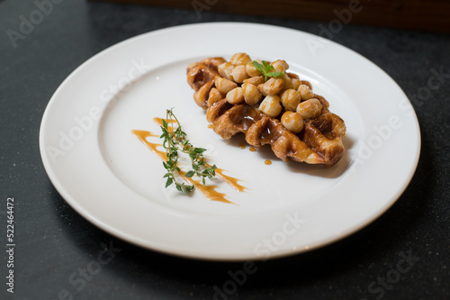 Croffle is a combination of croissant and waffle. This croffle served on a white plate 