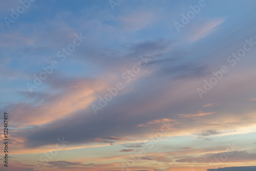 Beautiful evening sky with delicate clouds with orange and lilac, golden shades © Olga