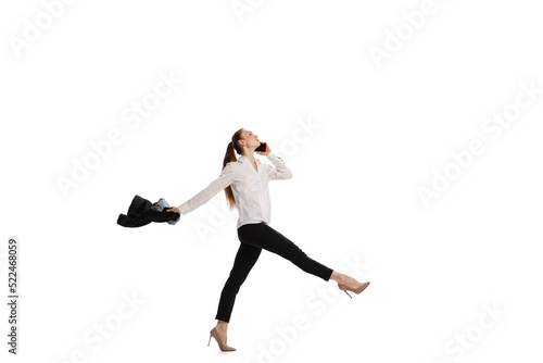 Happy business woman dancing and smiling isolated over white background. Emotions, finance, aspiration, business, job concept.