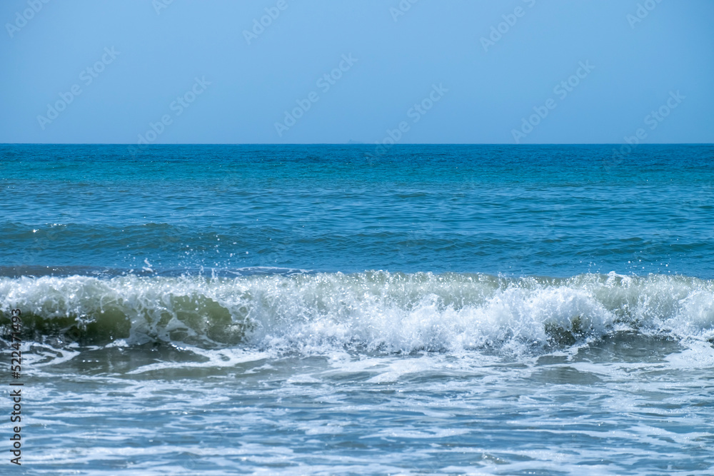 Fototapeta premium Ocean waves crashing on sandy beach. Sea waves breaking on Maditerranean's shore.