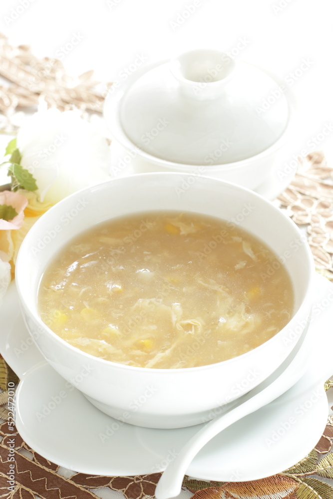 Homemade Chinese corn soup in white bowl with tea Homemade Chinese corn soup in white bowl with tea