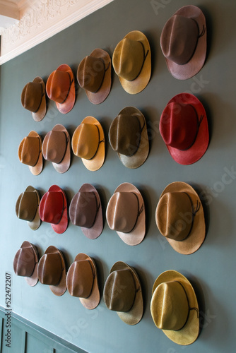 Colourful trilby hat collection, displayed on a wall. A multi coloured  selection of Trilby hats also known as the Fedora hat, as worn by Frank Sinatra. selective focus. Bright colourful display photo
