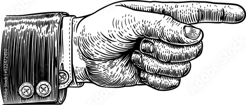 A hand pointing a finger in a direction sign. Wearing a business suit in a vintage antique engraving woodblock or woodcut style. photo