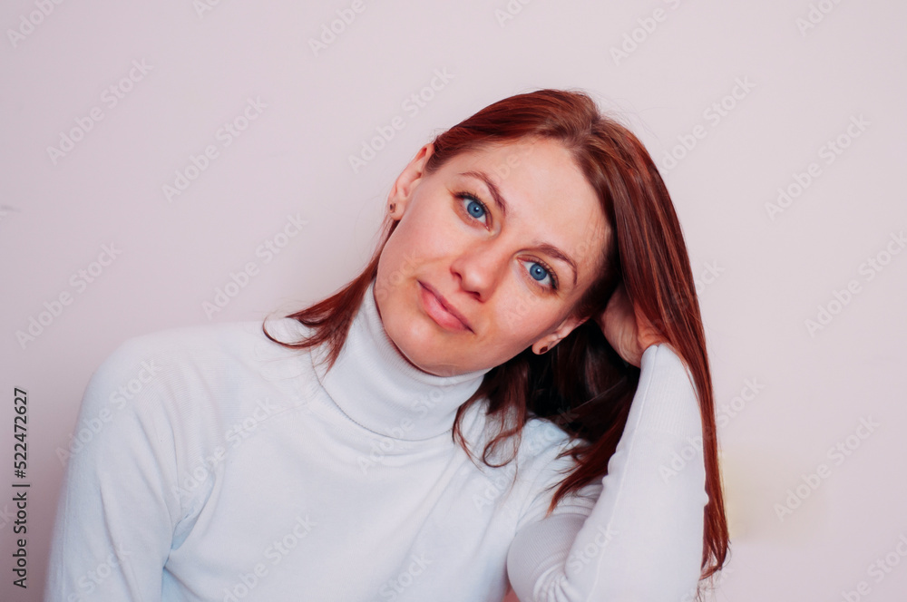 Obraz premium Portrait of a blue-eyed woman. Girl with red hair.