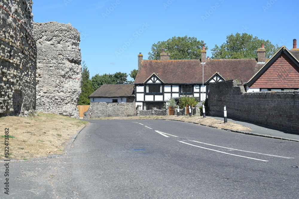 An English country road running by an English Medieval castle. 