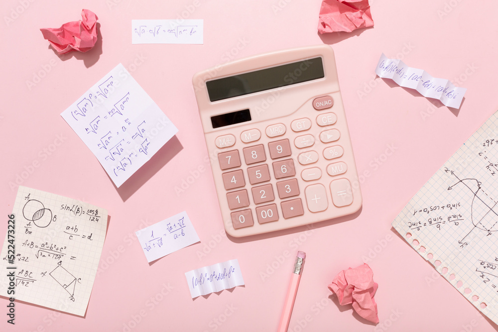 On a pink background, pink school supplies, a calculator, cheat sheets On a pink background, pink school supplies, a calculator, cheat sheets