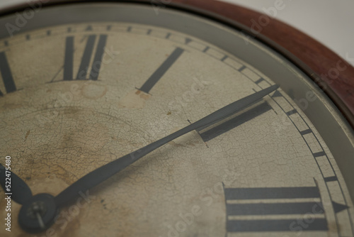 Details of an old clock on white wall