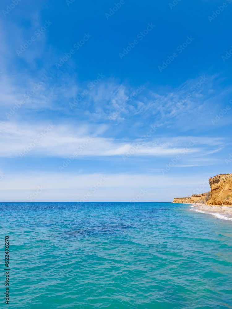 Inspiring summer sea, beach landscape view with beautiful blue sky with white clouds, sunlight and clay rocks