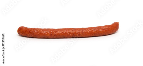 Foto One smoked grilled thin Pork Sausage, close-up, isolated on white background