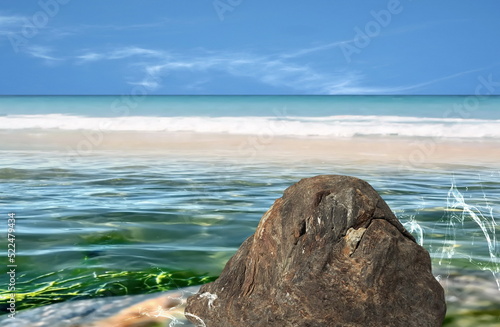 emerald green sea water and splash big stone rock palm tree leaves , white sand beach and blue sky tropical nature landscape defocus background