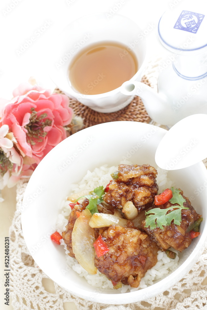 Chinese food, sour and sweet chicken on ricewith coriander leaves Chinese food, sour and sweet chicken on ricewith coriander leaves