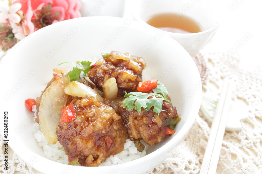 Chinese food, sour and sweet chicken on ricewith coriander leaves Chinese food, sour and sweet chicken on ricewith coriander leaves