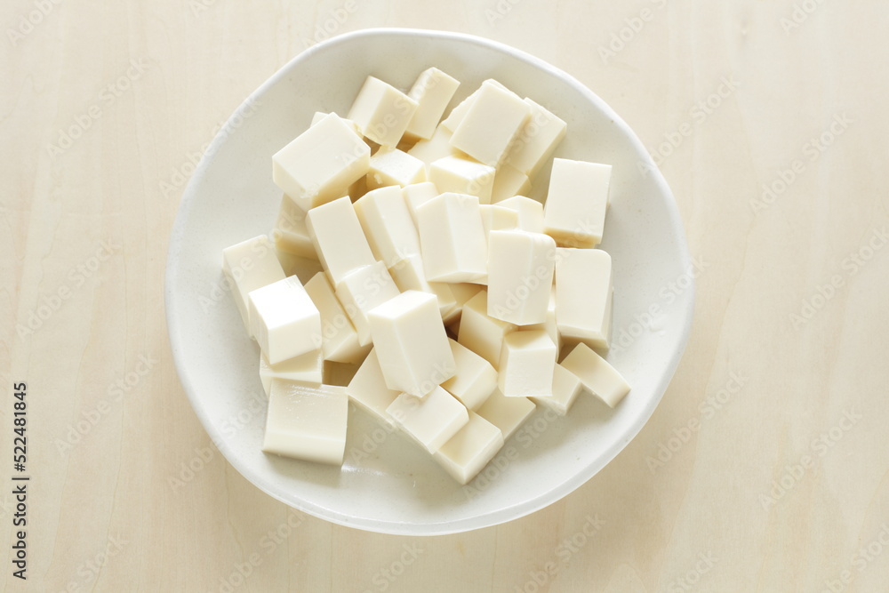 chopped Tofu on white dish with copy space for cooking ingredient chopped Tofu on white dish with copy space for cooking ingredient
