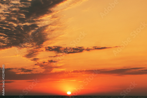 Beautiful sunset over the sea. Vertical shot. Clouds at dusk or dawn. Horizontal image.