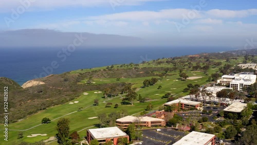 Aerial Panning Shot Of People At Torrey Pines Golf Course On Cliff By Sea During Sunny Day -  San Diego, California photo